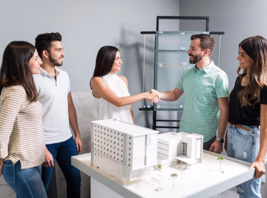business-partners-shaking-hands-with-engineer-by-architectural-model-meeting_662251-1666